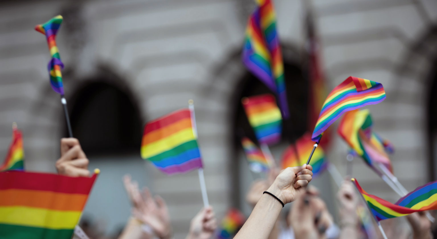 People waving pride flags