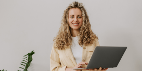 Confident woman in tech updating her CV on a laptop