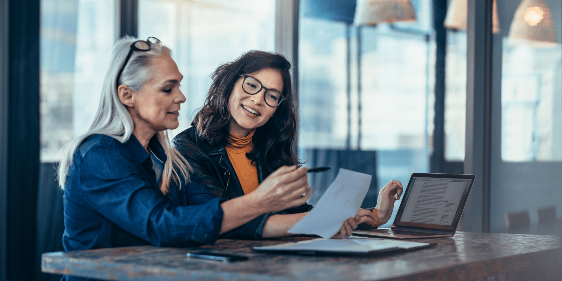 Woman in tech meeting with a mentor in modern office setting