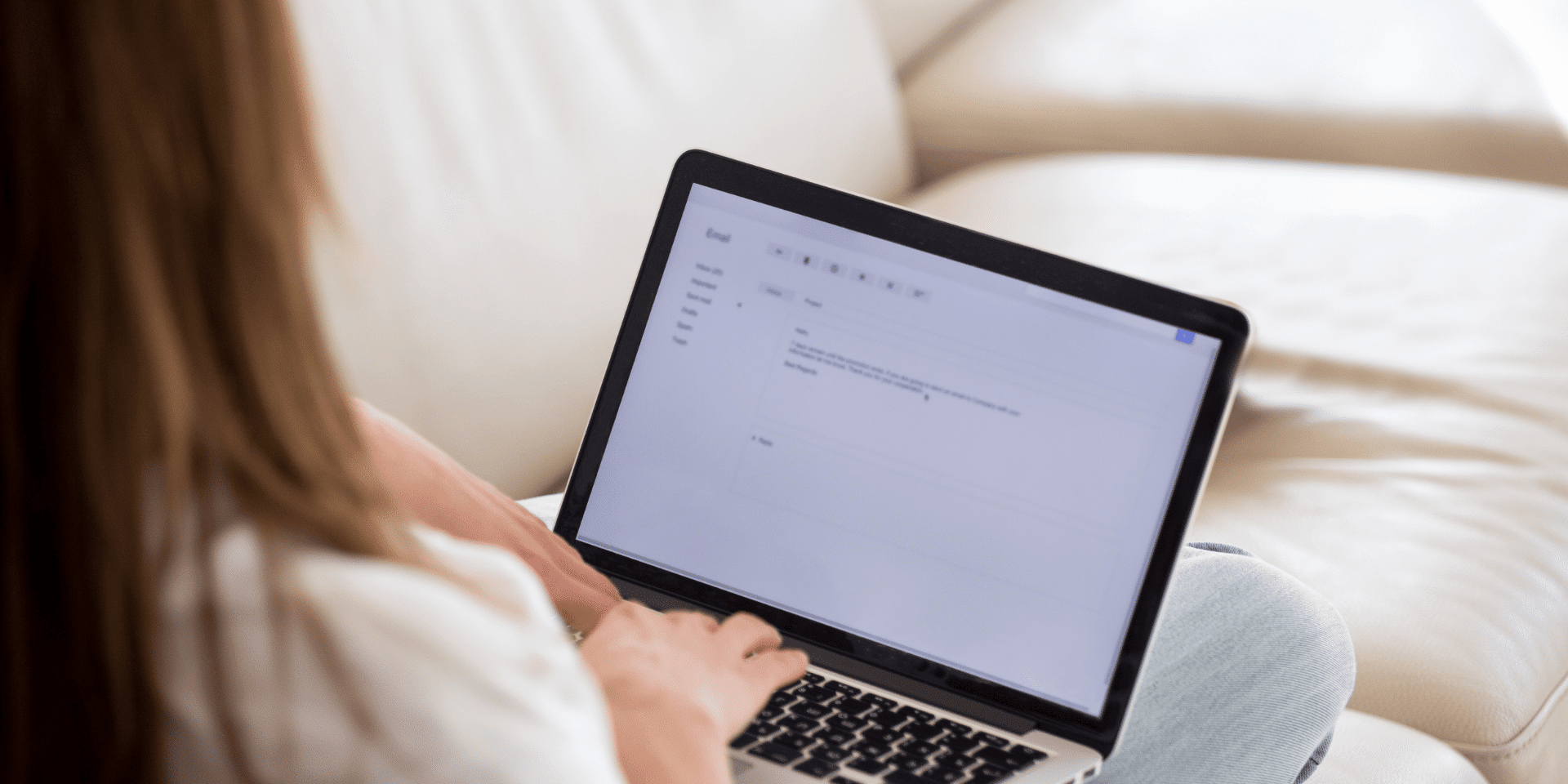 Woman writing a professional email during a business negotiation.