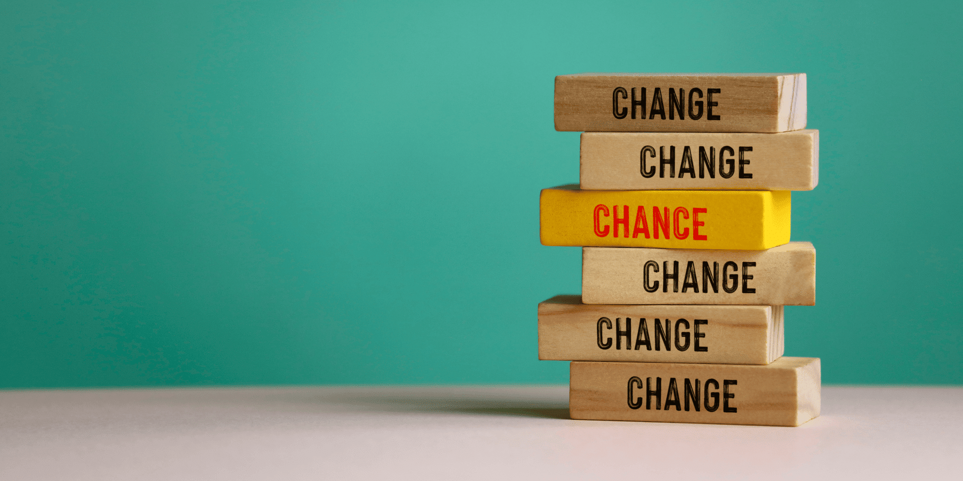 Stack of wooden blocks with the word “CHANGE” repeated, and one yellow block in the middle reading “CHANCE,” symbolising career transformation and opportunity.