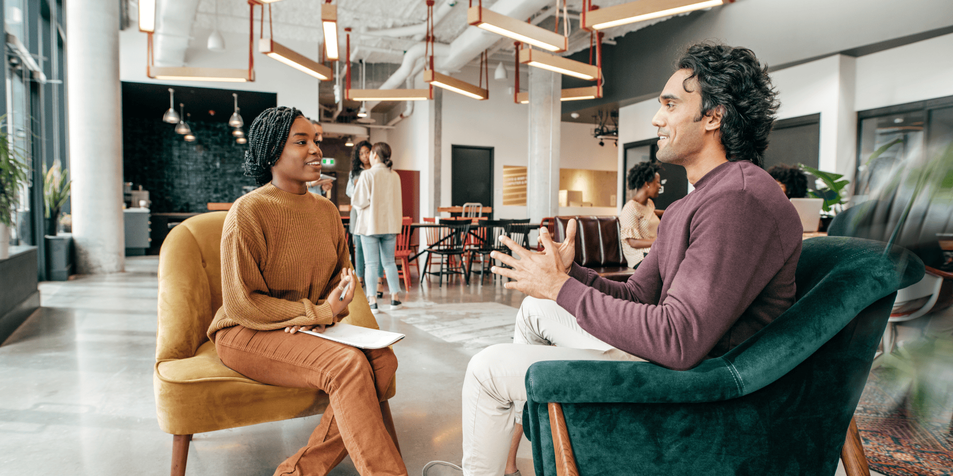 Woman in tech communicating confidently to colleagues in a modern workplace