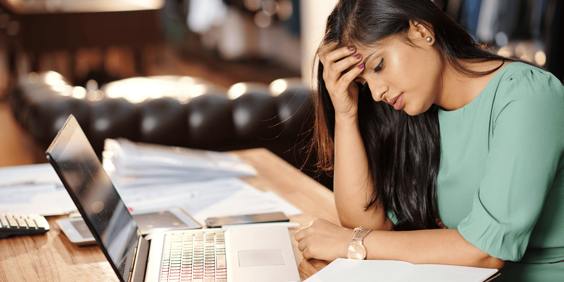 Woman looking concerned while working on a laptop, representing job uncertainty in the UK tech sector in Q2 2025